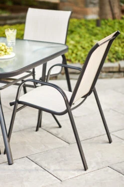 Style Selections Beige Stackable Outdoor Chair With Black Metal Frame 12 Style Selections Beige Stackable Outdoor Chair With Black Metal Frame -Style Selections 1063065 AlternateImage2